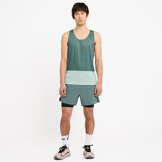 full picture of a model wearing the ciele athletics lightweight, race ready and performance driven singlet named RDSinglet in turquoise color from the lifetime edition, with the WRKShort in silver pine