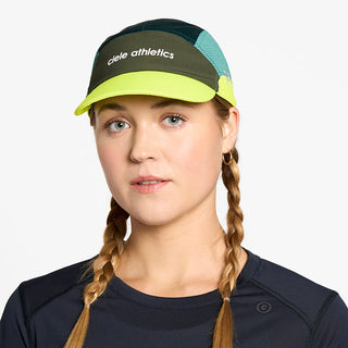 front view of the ciele athletics FTSCap unisex running hat in seaweed color, on a model