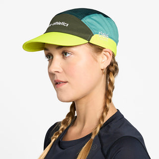 side view of the ciele athletics FTSCap unisex running hat in seaweed color, on a model