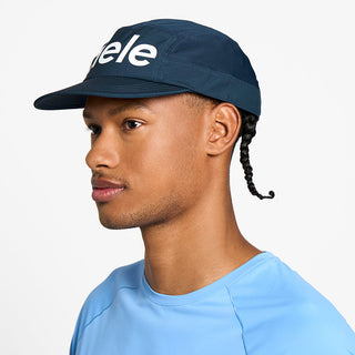 side view of the ciele athletics GOCap unisex running hat in deep space color, on a model
