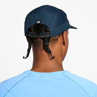 back view of the ciele athletics GOCap unisex running hat in deep space color, on a model