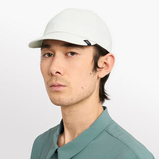 side view of ciele athletics CRWCap short brim unisex running hat with shorter brim from the Lifestyle Edition collection, in light grey color, on a model