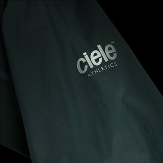 closeup view of the reflective sleeve logo of the ciele athletics VNTJacket lightweight running jacket for men in silver pine color, when reflective