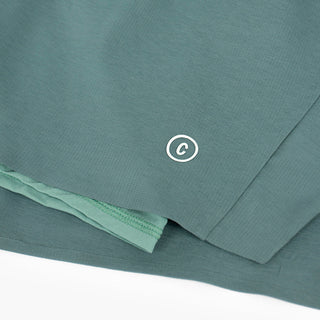 close view of the C logo and fabrics on the ciele athletics DLYShort 5 inch with a long brief in silver pine color