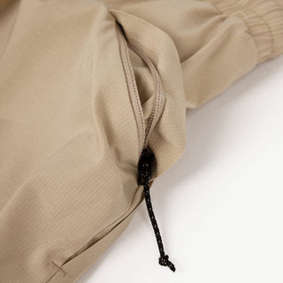 close view of the zippered side pocket of the ciele athletics ATShort 5 inch with liner short in safari color