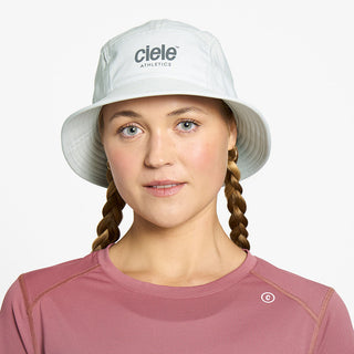 front view of ciele athletics GOBucket Comp Athletics unisex running bucket hat in light grey color on a model