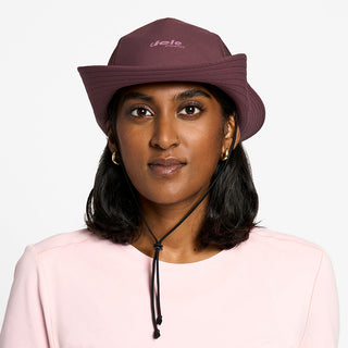 front view of the ciele athletics TRLBucket unisex running bucket hat in dark wine red color, on a model