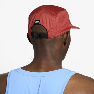 back view of ciele athletics GOCap unisex running hat in clay color on a model