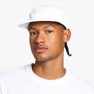 front view of the ciele athletics GOCap unisex running hat in ghost color, on a model