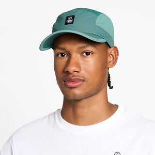 front view of the ciele athletics GOCap unisex running hat with a curved brim in silver pine color, on a model
