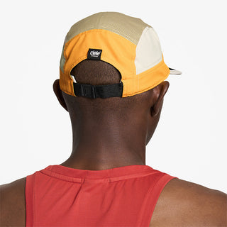 back view of ciele athletics GOCap Field Iconic Bar unisex running hat in clementine sand color on a model