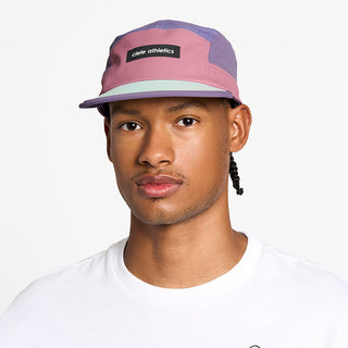 front view of the ciele athletics GOCap unisex running hat in deco rose color, on a model