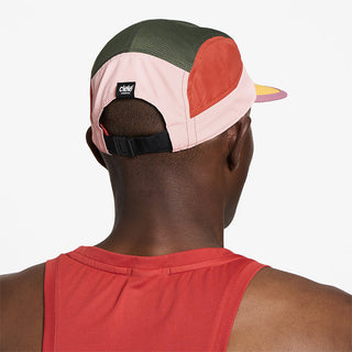 back view of ciele athletics GOCap Field Iconic Bar unisex running hat in peachskin seaweed color on a model