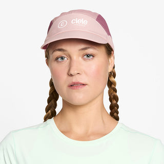 front view of ciele athletics FSTCap SC Classic C Side unisex running hat in peachskin color on a model