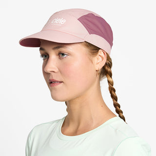 side view of ciele athletics FSTCap SC Classic C Side unisex running hat in peachskin color on a model