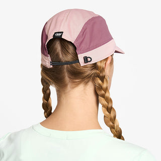 back view of ciele athletics FSTCap SC Classic C Side unisex running hat in peachskin color on a model