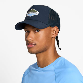 side view of the ciele athletics TRLCap unisex running hat with a curved brim in deep space color, on a model