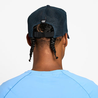 back view of the ciele athletics TRLCap unisex running hat with a curved brim in deep space color, on a model