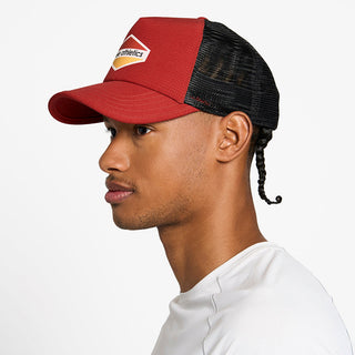 side view of the ciele athletics TRLCap unisex running hat with a curved brim in clay color, on a model