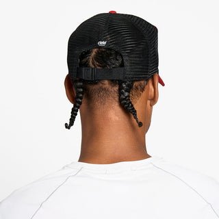 back view of the ciele athletics TRLCap unisex running hat with a curved brim in clay color, on a model
