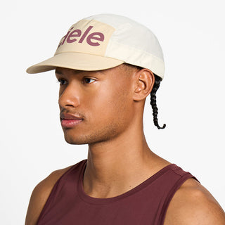 side view of the ciele athletics GOCap unisex running hat in safari color, on a model