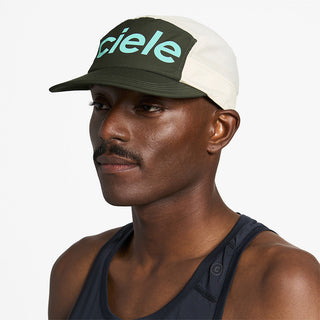 side view of ciele athletics GOCap Comp Century unisex running hat in seaweed rainy day color on a model