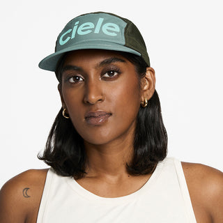 front view of the ciele athletics GOCap unisex running hat in silver pine color, on a model