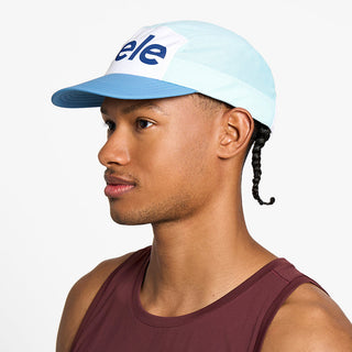side view of the ciele athletics GOCap unisex running hat in white sky blue color, on a model