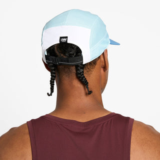 back view of the ciele athletics GOCap unisex running hat in white sky blue color, on a model