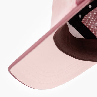underbrim view of the ciele athletics FSTCap unisex running hat with a curved brim in peachskin color