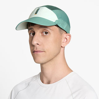 side view of ciele athletics FSTCap SC Comp Iconic VC unisex running hat in dusty turquoise emerald color on a model