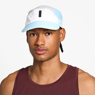 front view of the ciele athletics FTSCap unisex running hat with a curved brim in white color, on a model