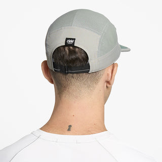 back view of ciele athletics GOCap EQ Frames unisex running hat in neutral grey color on a model