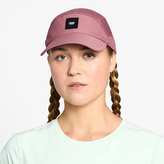 front view of the ciele athletics FTSCap unisex running hat with a curved brim in deco rose color, on a model