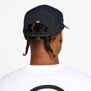 back view of the ciele athletics GOCap with a curved brim unisex running hat in whitaker color, on a model