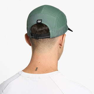 back view of ciele athletics GOCap Comp C cube unisex running hat in silver pine color on a model