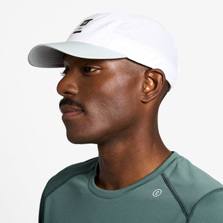 side view of ciele athletics GOCap Comp C cube unisex running hat in white color on a model