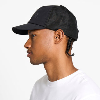 side view of the ciele athletics TRLCap unisex running hat with a curved brim in shadowcast color, on a model