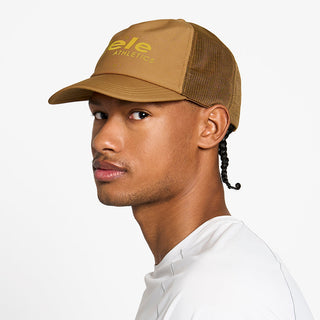 side view of the ciele athletics TRLCap unisex running hat with a curved brim in dark ochre color, on a model