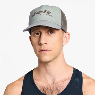 front view of ciele athletics TRLCap SC Comp one hundred unisex running hat in neutral grey color on a model