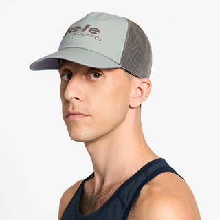 side view of ciele athletics TRLCap SC Comp unisex running hat in neutral grey color on a model