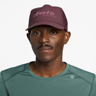 front view of ciele athletics TRLCap SC Comp one hundred unisex running hat in dark wine red color on a model