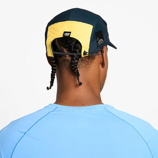 back view of ciele athletics GOCap SC Comp Word Wild Mouvement unisex running hat for the Boston marathon on a model