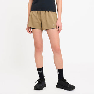 person wearing tan athletic shorts and black socks on a white background