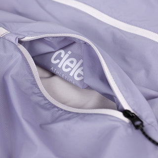 closeup view of the inside pocket logo of the ciele athletics VNTJacket lightweight running jacket for women in grape color